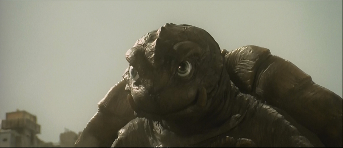 Gamera, following in Gorgo's tiretracks