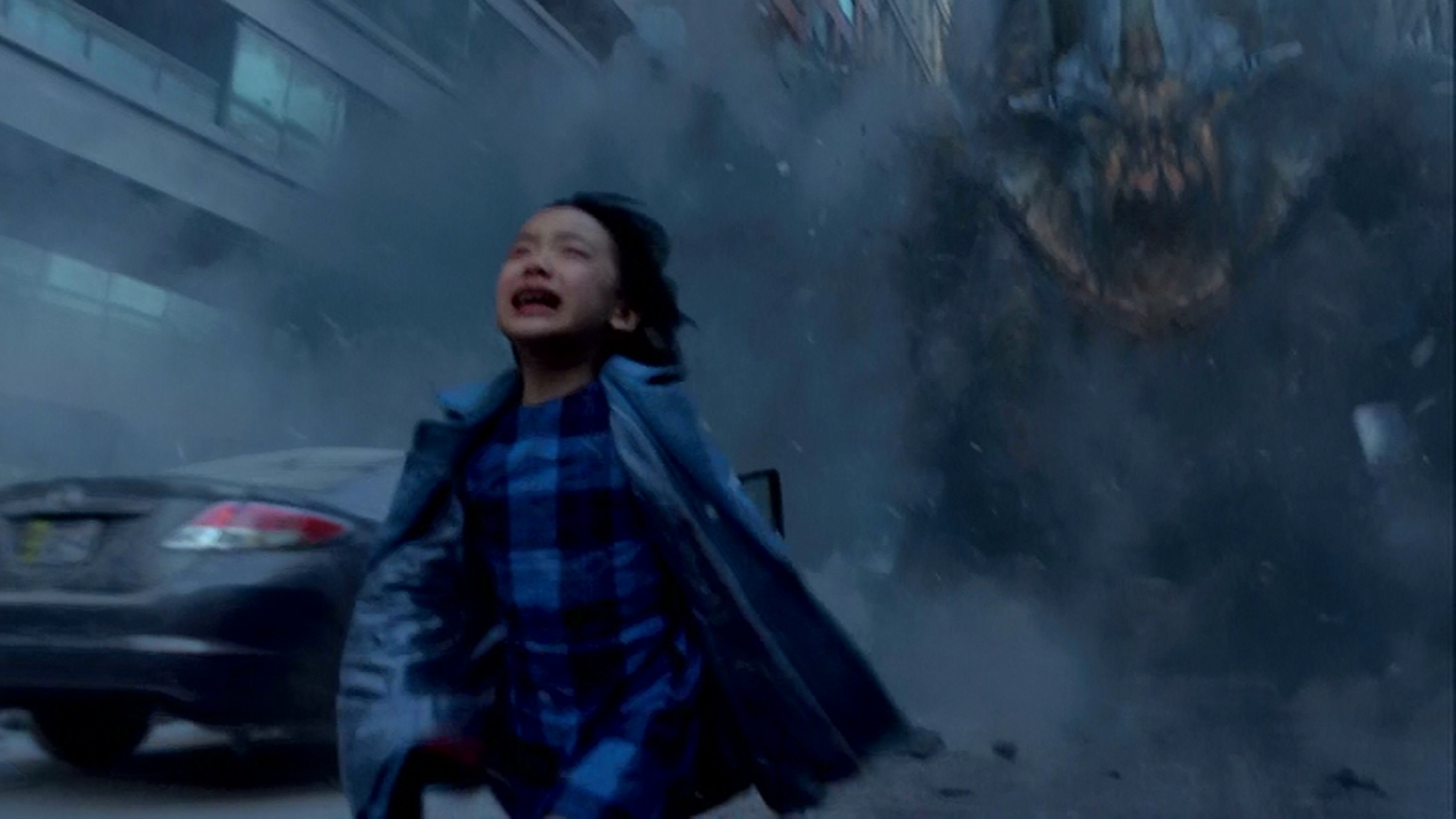 Young Mako Mori runs from the terrifying monster.