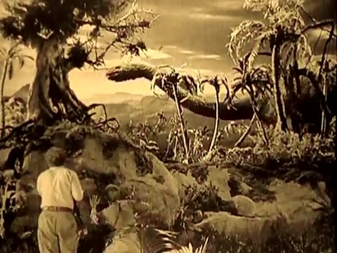 In the foreground, humans.  In the background, dinosaurs, from the 1925 Lost World.